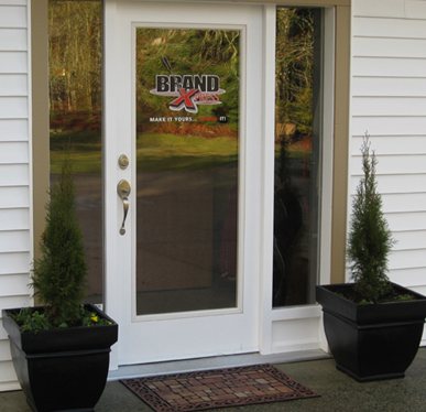 The Brand Xpress shop door with the Brand Xpress logo on the glass